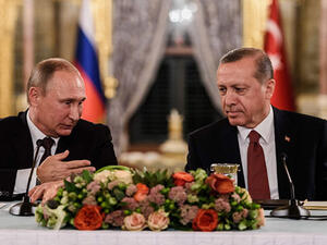 This file photo taken on October 10, 2016 shows Russian President Vladimir Putin (L) speaking to Turkish President Recep Tayyip Erdogan (R) as they attend a press conference in Istanbul (AFP/File) 