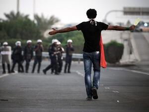 A Bahraini protester walks towards local riot police. (AFP/Mohammed Al Shaikh)
