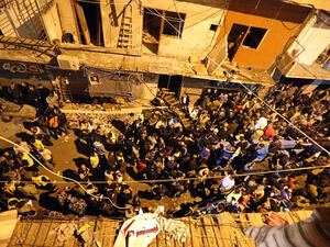 Civilians and army soldiers gather at the site of a twin suicide bombing in Burj al-Barajneh, in the southern suburbs of the capital Beirut. (AFP/File)