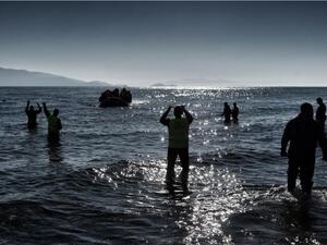 A boat carrying refugees and migrants arrives on a Greek island, after crossing the Aegean sea from Turkey in February. (AFP/Aris Messinis)