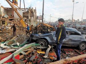A boy in Baghdad inspects a car bombing in December. At least 17,000 Iraqi civilians were killed last year. (AFP/Ahmad Al-Rubaye)