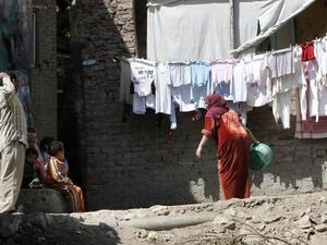 Members of an Egyptian family gather outside their house in a Cairo slum. (AFP/File)
