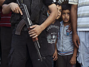 Palestinian boys watch as Hamas militants parade in Shejaiya, Gaza, following the brutal conflict with Israel in 2014. The highest levels of extremism are in countries experiencing ongoing conflicts, where children are particularly vulnerable to recruitment. (AFP/Roberto Schmidt)