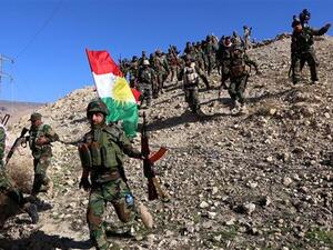 Iraqi Kurdish Peshmerga forces and fighters from the Izadi community hold a Kurdish flag while entering the northern Iraqi town of Sinjar, in the Nineveh Province, November 13, 2015. (Twitter)