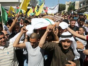 Palestinian mourners carry the body of Hadeel al-Hashlamon,18, during her funeral in the occupied West Bank city of Hebron on Sept. 23, 2015. (AFP/Hazem Bader)