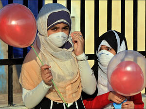 Two Egyptian girls wear masks to protect against swine flu. (AFP/File)