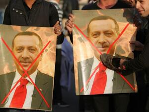 Iraqis hold crossed-out portraits of Turkey's President Recep Tayyip Erdogan during a December 2015 demonstration to demand the withdrawal of Turkish forces from Iraq. (AFP/Ahmad Al-Rubaye)
