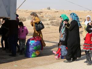 Iraqi women and children who have fled Fallujah wait at an army checkpoint. (AFP/Ahmad al-Rubaye)