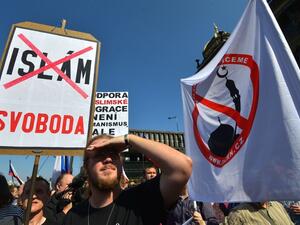 Protesters hold banners and Czech national flags during an anti-refugee rally on September 12, 2015 in Prague. (AFP/Michal Cizek)