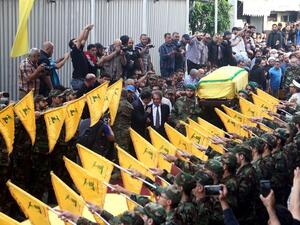 The coffin is carried through the Hezbollah controlled Dahiyeh district of Beirut. (AFP/File)