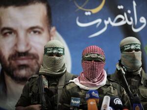 Members of the Ezzedine al-Qassam Brigades, the armed wing of Hamas, address a press conference in Gaza City on 22 November 2012. (Twitter)
