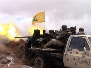 A handout picture released by the Hezbollah press office on May 16, 2015, shows a Hezbollah fighter firing towards Daesh militants on the Syrian side of the Qalamoun hills close to the Lebanese border. (AFP/File)