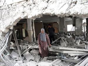 A Palestinian woman walks amid the rubble of a house after Israeli security forces demolished the home of her family. (Twitter)
