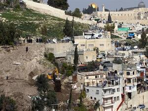 In this file photo, an Israeli army bulldozer destroys Palestinian houses in the East Jerusalem area of Silwan. (AFP/File)