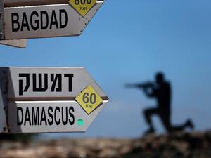 A sculpture of an Israeli soldier standing guard is seen next to a sign for tourists. (AFP/File)
