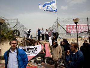 Israeli settlers barricade themselves at a synagogue in the West Bank settlement of Givat Zeev. (AFP/File)
