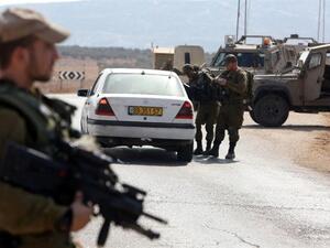 Israeli soldiers inspect a Palestinian car at a checkpoint close to the West Bank village of Beit Furik, east of Nablus, on October 2, 2015. (AFP/Jaafar Ashtiyeh)