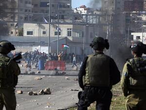 Israeli soldiers look on during a crackdown on Palestinian Birzeit University students outside the Ofer prison near Ramallah on 13 February 2012. (AFP/File)