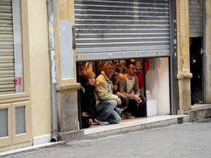 Residents find a safe space inside of one of the city's stores after the explosion. (AFP/Bulent Kilic)