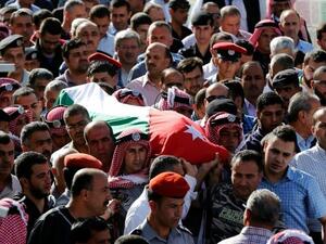 Jordanian mourners carry the body of intelligence corporal Omar al-Hayari, one of the five men killed in the attack. (AFP/File)