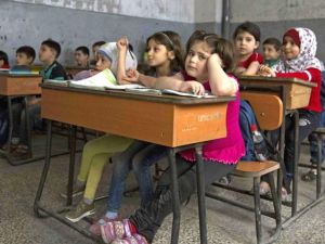 Syrian children attend a class at a primary school in Aleppo's rebel-held eastern district of Shaar on Saturday. (AFP/File)