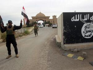 A Shia militia fighter celebrates the liberation of Tikrit. (AFP/Ahmed al-Rubaye)