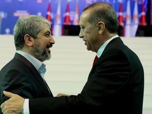 Turkey's Prime Minister Recep Tayyip Erdogan, right, and Palestinian Hamas leader Khaled Meshaal. (AFP/File)