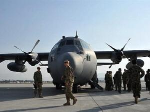 This file photo shows American soldiers close to a C-130 Hercules military transport plane. (AFP/File)