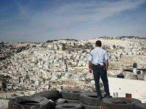 A Palestinian looks towards the sprawling illegal Israeli settlements of East Jerusalem. (AFP/File)