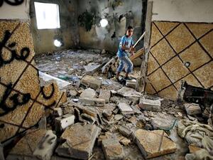 A Palestinian walks through a destroyed home in Silwan after it was razed by Israeli authorities in March. (AFP/Ahmad Gharabli)