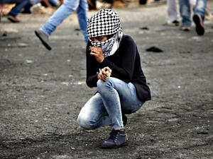 A Palestinian young woman from the Birzeit University looks on during clashes with Israeli security forces. (AFP/File)