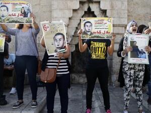 Palestinian protesters hold posters during a demonstration against administrative detention and in support of Palestinian prisoner Bilal Kayed (portraits) on August 24, 2016 at Damascus Gate, a main entrance to Jerusalem's Old City. (AFP/Ahmad Gharabli)