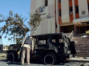 An Egyptian policeman inspects the wreckage after a car bomb blast kills three policemen in al-Tur, in the Sinai peninsula, on October 7, 2013. (AFP Photo/Mohamed el-Shahed)