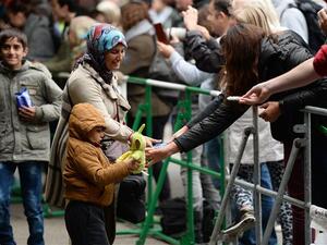 A refugee family receives presents as they arrived at the train station in Munich, southern Germany. (AFP/File)