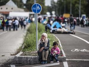 A mother and child sit on the street contemplatively. (AFP/Armend Nimani)
