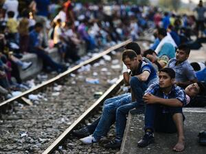 Refugees wait for a train heading to Serbia at the Gevgelija railway station, on the Macedonian-Greek border on July 28, 2015. (AFP/Dimitar Dilkoff)