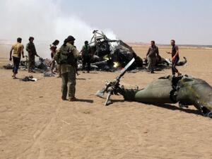 Syrian rebels gather around the wreckage of a Russian Mi-8 military transport helicopter. (AFP/File)