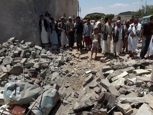 Yemenis gather near the rubble of houses close to Sanaa Airport, March 31, 2015, after they were destroyed in an air strike a Saudi-led coalition warplanes. (AFP/ Mohammed Huwais) 
