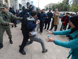 Unemployed and visually impaired Moroccan graduates scuffle with security forces as they try to enter the Ministry of Solidarity, Women, Family and Social Development in Rabat, on Thursday, to protest against unemployment. (AFP/File)