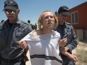 An Israeli settler being evacuated from an illegal settlement. (AFP/Menahem Kahana)