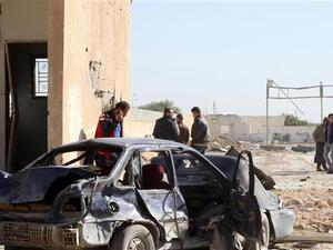 Libyans gather at the site of a deadly truck bombing on a police school in Libya's Sirte. (AFP/File)