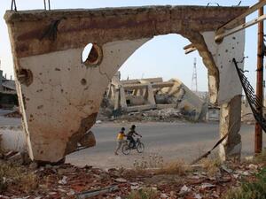 Syrian boys on a bicycle on May 14, 2016 in the southern city of Daraa. (AFP/File)