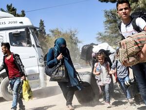 Syrian refugees walk on their way back to the Syrian city of Jarabulus on September 7, 2016. (AFP/File)
