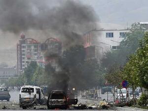 Smoke and flames rise from burning vehicles at the site of an attack in front of the Afghan parliament building in Kabul on June 22, 2015. (AFP/Shah Marai)