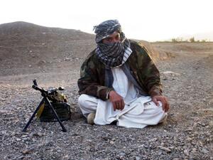 In this file photo taken on September 26, 2008, a fighter with Afghanistan's Taliban militia poses with a machine-gun in Wardak province. (AFP/File)