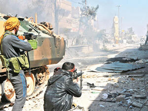 Turkey-backed Syrian opposition fighters take position during their advance in the city of Al-Bab, 30 km from the Syrian city of Aleppo. (AFP/File)