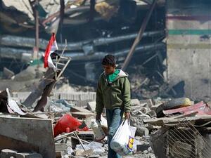 A Yemeni boy walks amid the ruins of a school and a bowling club hit by Saudi airstrike in the capital Sana'a, on February 12, 2016. (AFP/File)