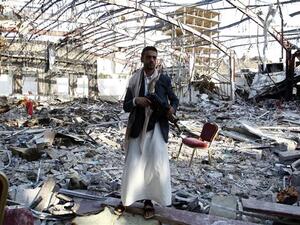 A Yemeni man stands on October 24, 2016 at the site of a Saudi airstrike on a funeral ceremony that killed 140 people and wounded 525 others earlier this month. (AFP/File)