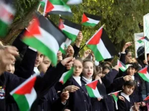 Children wave the Palestinian flag. Support is growing around the world for Palestinian state recognition following the recent 50-day conflict in the Gaza Strip (AFP/File Archive).
