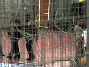 Palestinian prisoners walk at the yard of Megiddo Prison. (AFP/Menahem Kahana) 